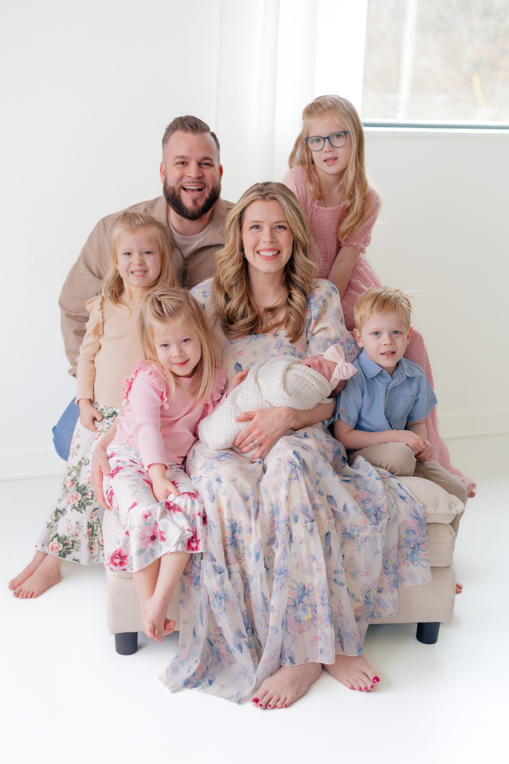 large family gathered around newborn baby in studio portrait - St Louis family photographer