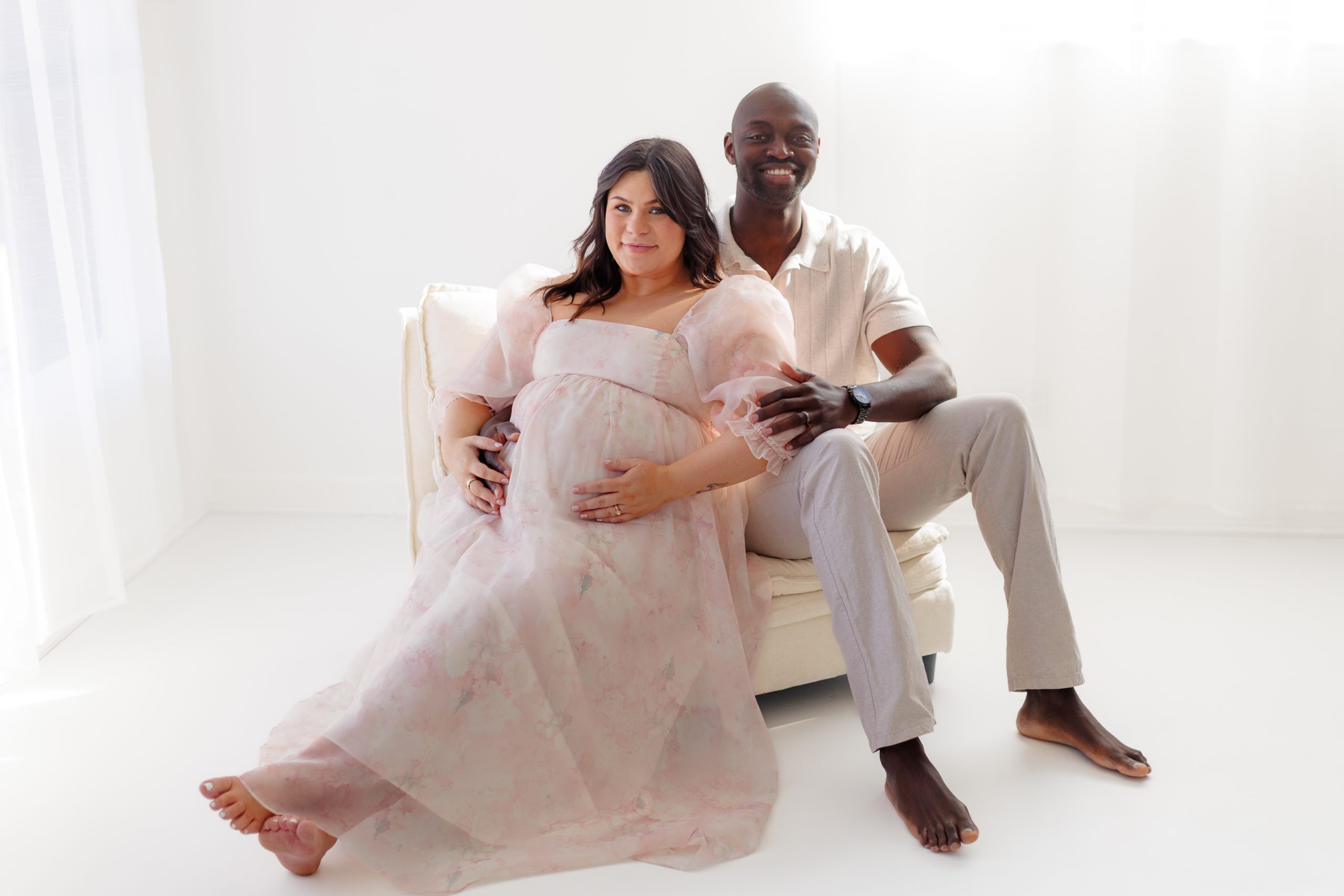 expecting parents sitting together during studio maternity session - St Louis maternity photographer