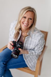 Kira Messer St Louis photographer smiling while holding camera